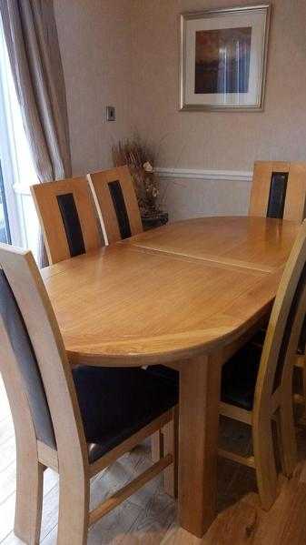 Large extendable solid oak dining table and 6 chairs