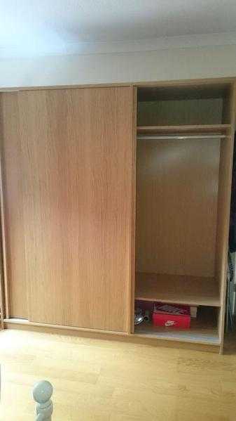 Large oak veneered sliding door wardrobe