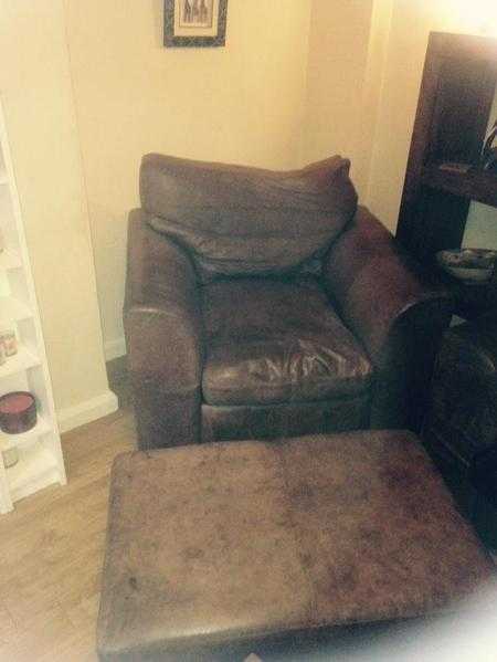 Leather Armchair in chocolate brown with matching footstool.