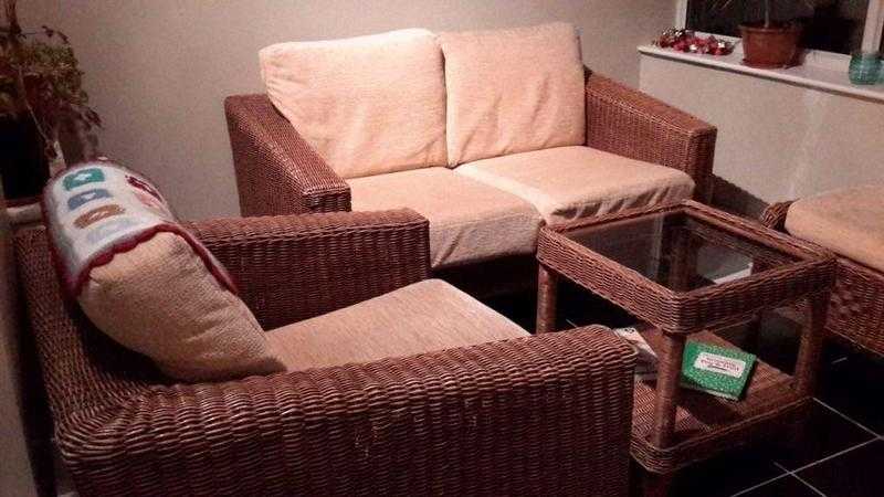 Lovely set of a two-seater wicker sofa, two chairs and glass-top coffee table