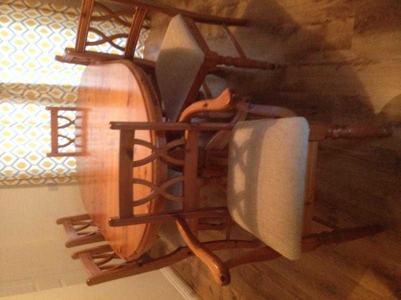 Oak extending table four chairs and two carver chairs .beige material covered chairs