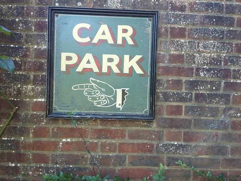 old wooden car park sign