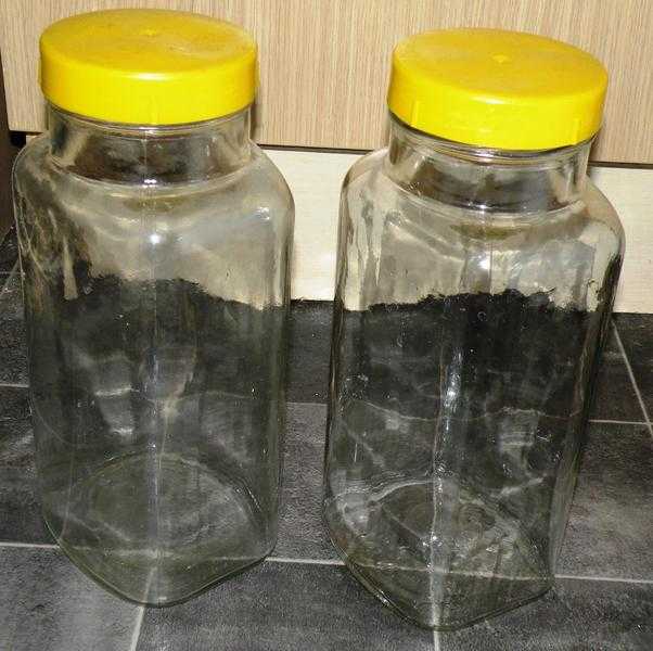 Pair of vintage glass storage jars with yellow lids