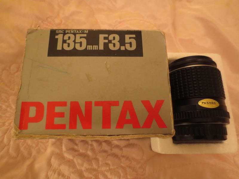 Pentax zoom lens-virtually unused- in original boxpackaging.