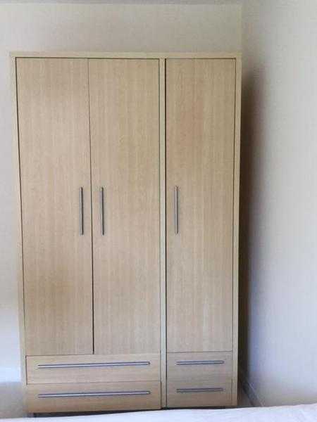 Pine coloured 3 door, 4 drawer wardrobe