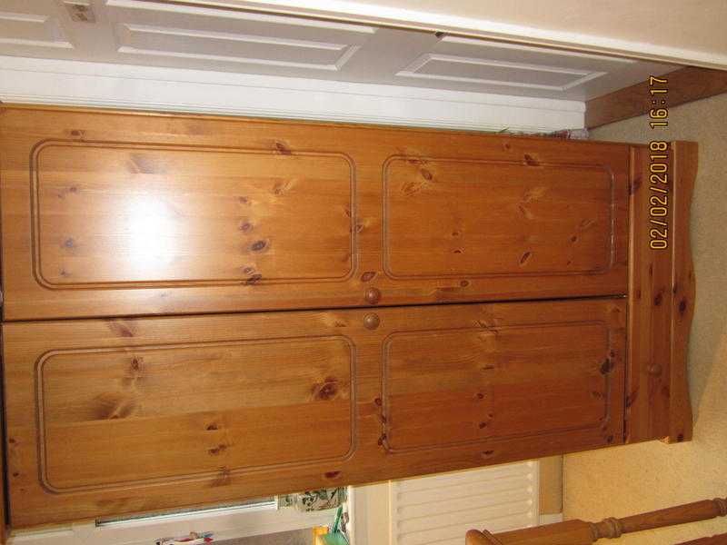 Pine double door wardrobe with drawer.