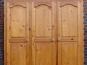 Pine looking triple wardrobe with top box and drawer underneath