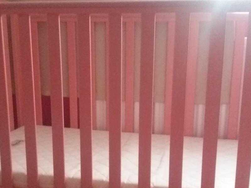 pink cot and mattress