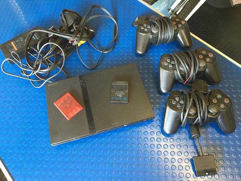 PLAYSTATION 2 WITH GAMES AND 3 CONTROLLERS AND 2 CARDS