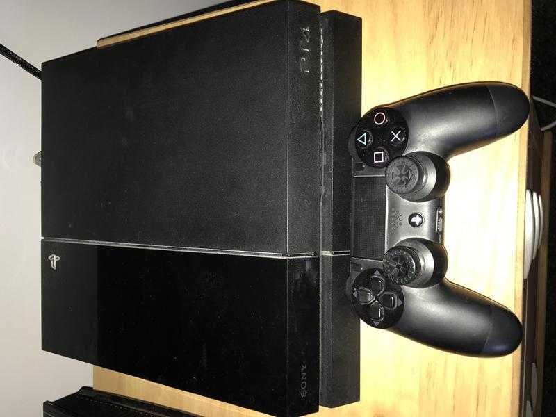 PlayStation 4 for sale with games and controller