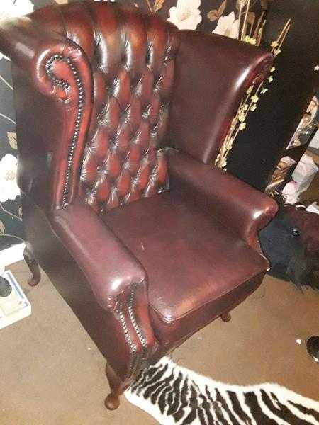 Red oxblood leather wing back club chair .