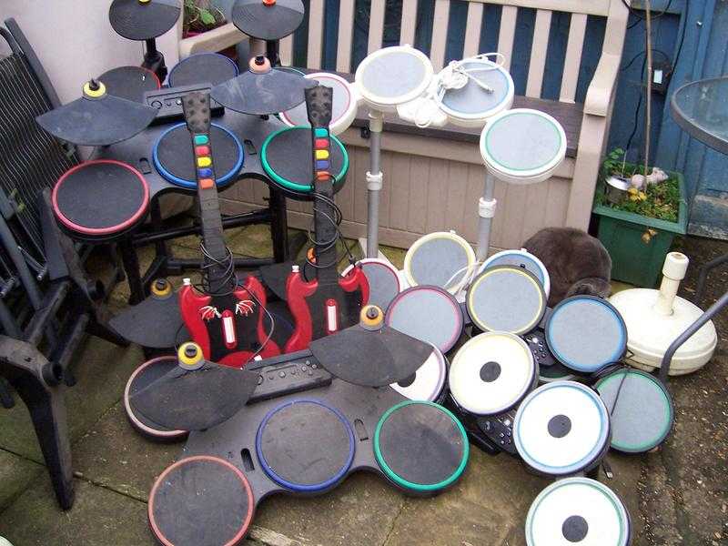 Selection of 8 gaming drums and 2 guitars.