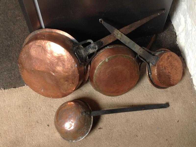 Set of ornamental copper pans and ladle