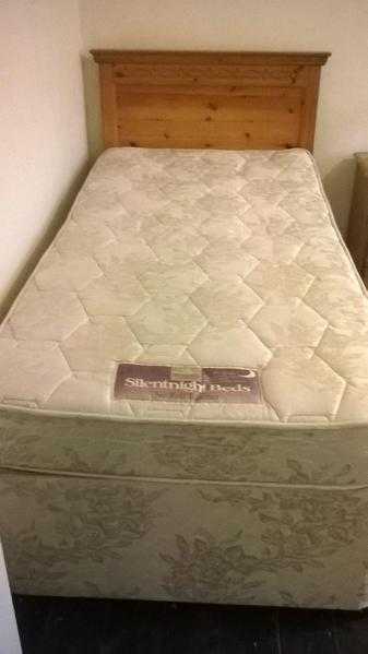 Single bed with Silentnight mattress and wooden headboard.