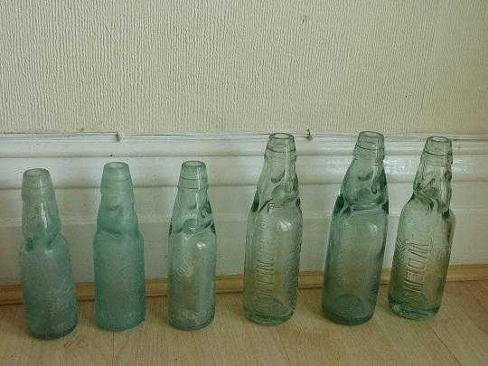 SIX OLD BOTTLES WITH MARBLES INSIDE