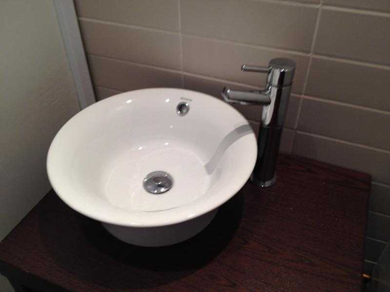 small basin with matching tall tap