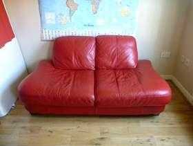 Small red faux leather sofa