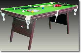 Snooker table with cues, rests, chalk and balls