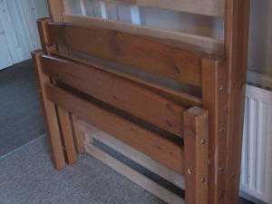Solid antique pine single bed frame with 2 large under bed storage draws on wheels.