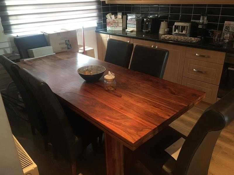 Solid wood dinning table and six real leather brown chairs