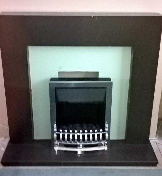 Solid wood fire surround includes fire