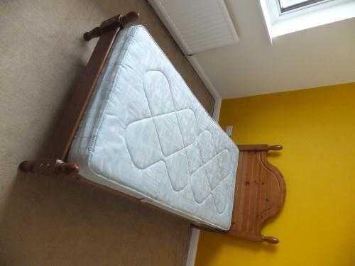 Standard single wooden bed frame and mattress