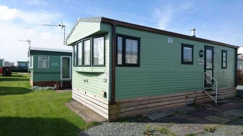 Static Caravan for sale. Lovely Condition. Ideal for first time buyer. 12mth Pet Friendly Holiday Park. Sea Views and Decking included