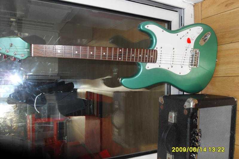 stratocaster style electric guitar and 15 watt cruiser amplifier