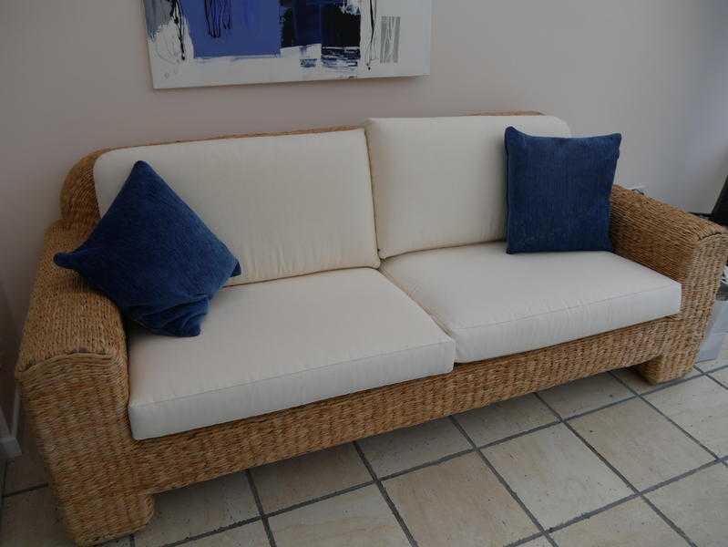 Stylish banana leaf and cream sofa, ideal for a conservatory