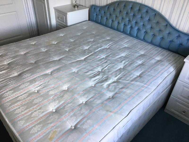 super king size bed with mattress and blue headboard