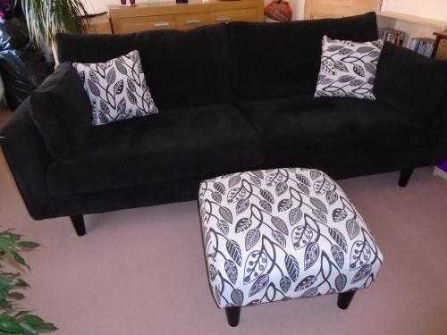 Superb large black sofa, excellent condition, with matching black  white footstool  two cushions