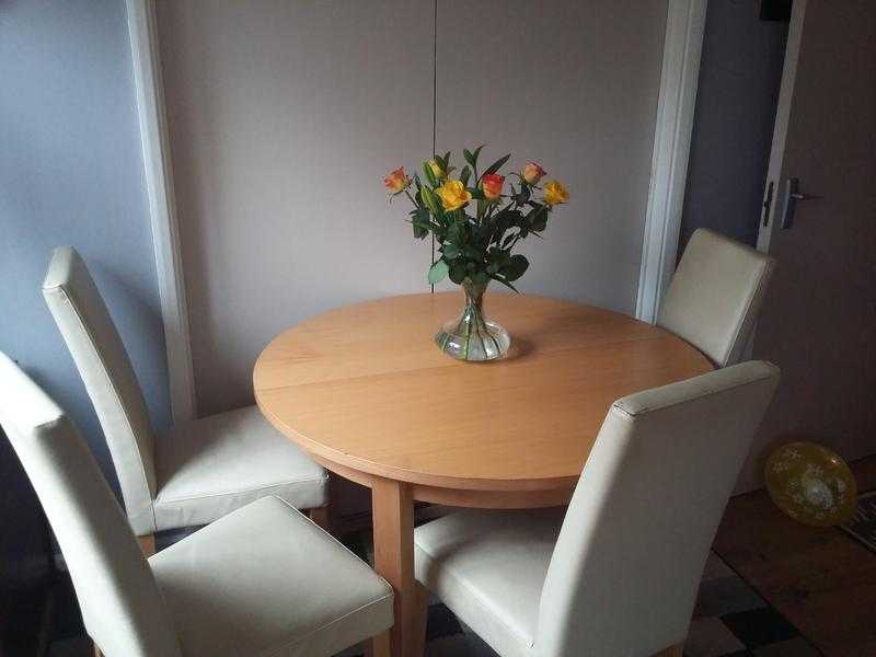 Table with 4 leather chairs.