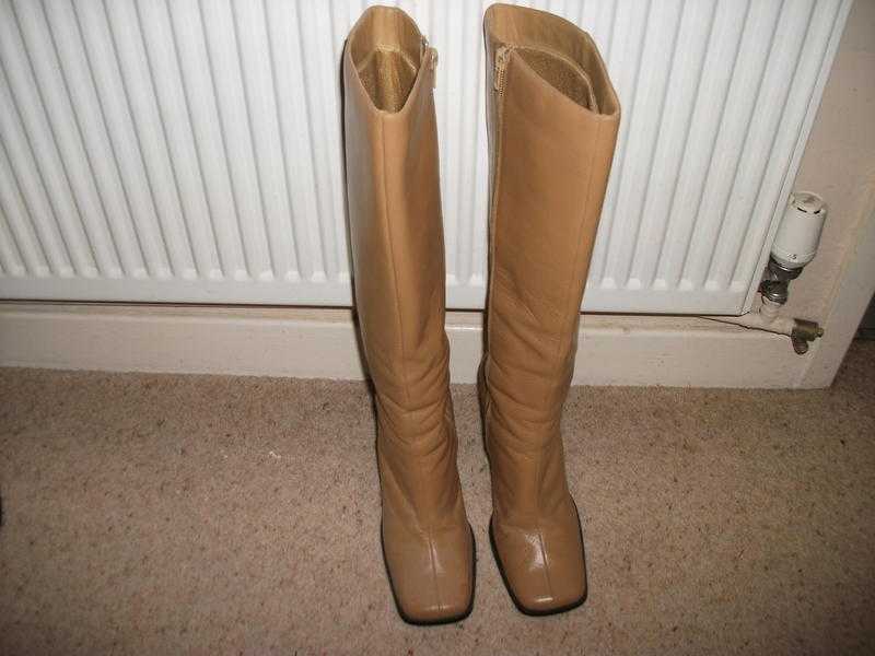 Tan knee high boots.