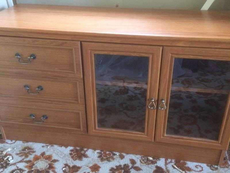 Teak effect low level unit with 3 drawers and glass fronted cupboard