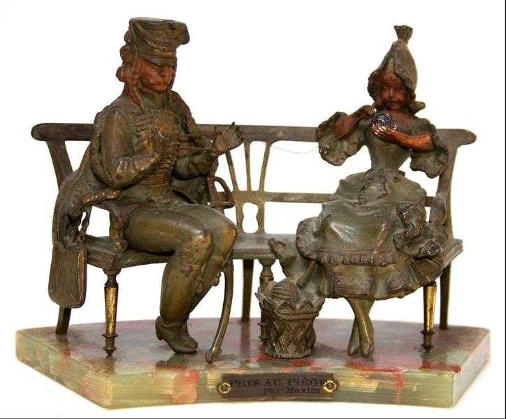 The girl and the soldier on bench with a bronze on the basis of onyx