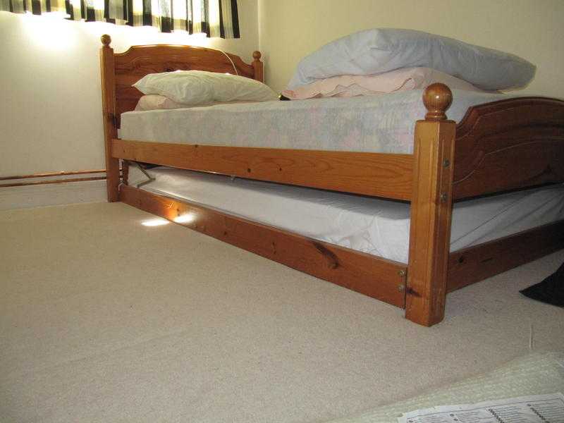 Twin Stowaway Pine Single Beds with mattresses.