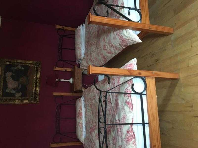 Two beautiful iron and wood single beds