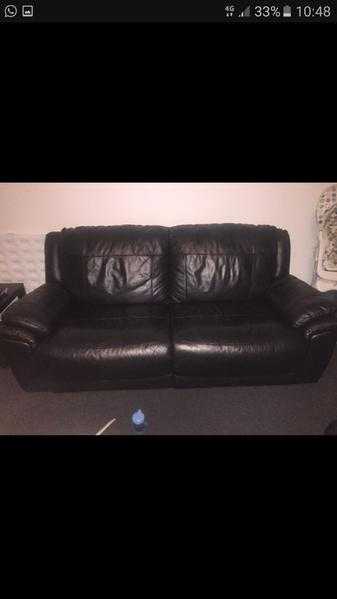 Two black leather sofas
