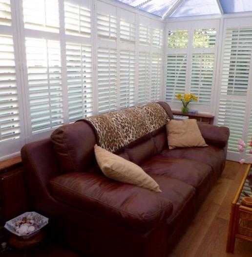 Two brown leather sofas