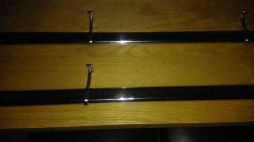 Two chrome curtain poles with wall fittings