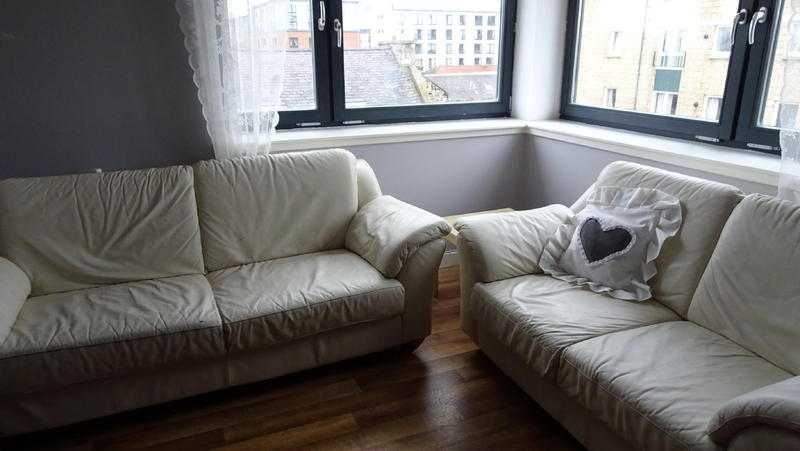 Two cream leather sofas