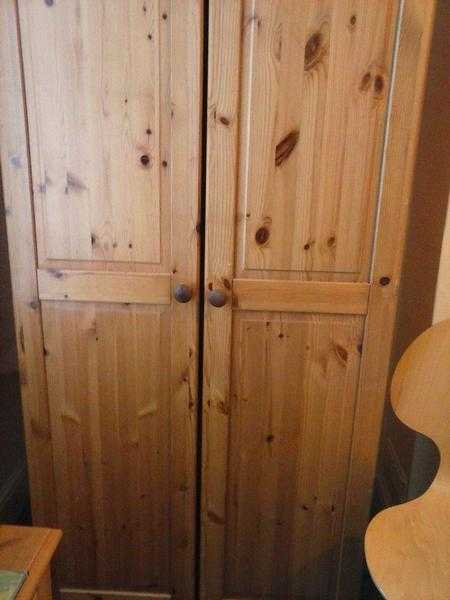 Two door  solid wooden  pine wardrobe. Hanging rail, and shelf. Very good condition.