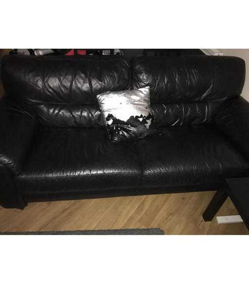 Two identical 2 seater sofas black leather with ottom footstool