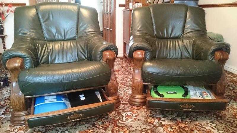 TWO LEATHER ARM CHAIRS. dark green colour. Solid oak frames.