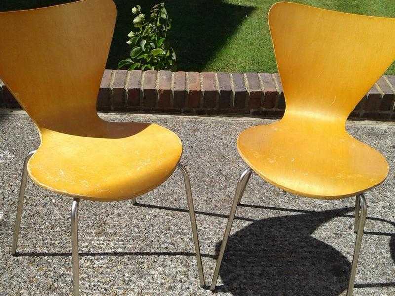 Two matching light wood chairs with metal legs