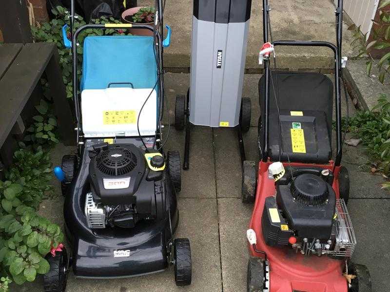 Two petrol lawnmowers and one garden shredder