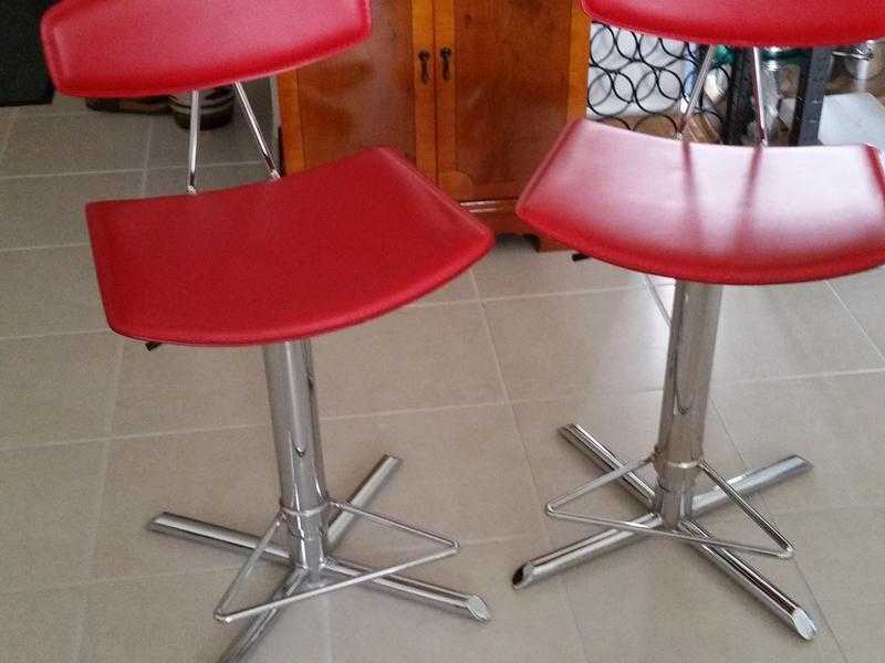 Two Red Leather Bar Stools with chrome stands