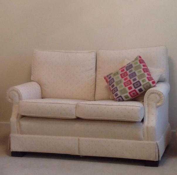 Two seater cream sofa