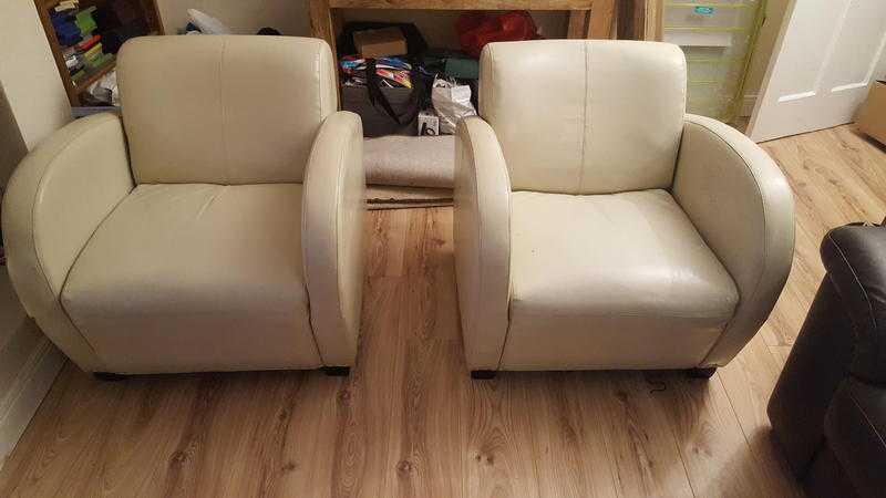 Two solid designer leather arm chairs for free.