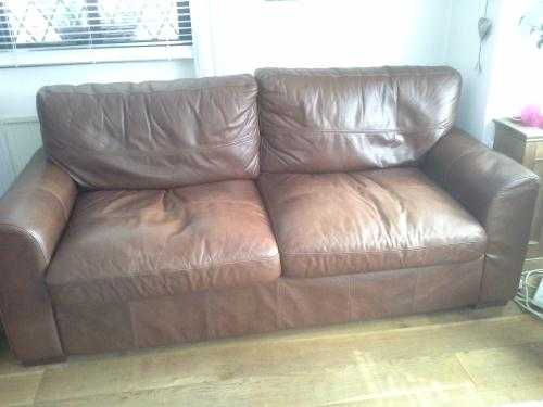 Two tan, full leather sofas